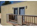 Condo balcony with wood railing and nearby entrances at 2711 Mapleton Ave # 27, Boulder, CO 80304