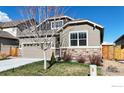 Well-maintained single-Gathering home with a manicured lawn and stone detailing at 2842 Tallgrass Ln, Berthoud, CO 80513