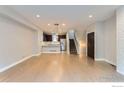 Spacious living room featuring hardwood floors, modern lighting and an open layout with eat-in kitchen at 3150 Vallejo St, Denver, CO 80211