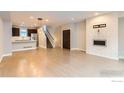 Modern living area showcases hardwood floors, a decorative fireplace and a seamless flow to the kitchen at 3150 Vallejo St, Denver, CO 80211