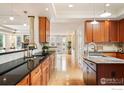 Spacious kitchen with granite countertops, wooden cabinetry, and modern appliances at 3151 6Th St, Boulder, CO 80304