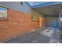 Exterior shot highlighting the brick facade, attached carport, and covered entrance at 345 S Forest St, Denver, CO 80246