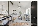 A modern living room with a high ceiling, wood floors, and neutral decor at 4223 Peach Way, Boulder, CO 80301