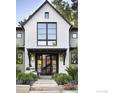 Elegant entryway with modern glass doors and lush, colorful landscaping at 440 Japonica Way, Boulder, CO 80304