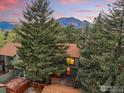 Scenic aerial view of the property showcasing mountain views and mature evergreens at 4604 Greenbriar Ct, Boulder, CO 80305