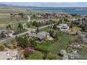 Aerial view of a neighborhood near a lake with mature trees, lush lawns, and a pool in the backyard at 5288 Waterstone Dr, Boulder, CO 80301