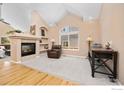 Cozy living room showcasing a fireplace, built-in shelves, and ample natural light at 5912 Thistle Ridge Ave, Firestone, CO 80504