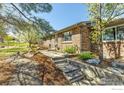 Well-maintained brick home with professional landscaping, showcasing concrete steps and a retaining wall at 601 Candice Ct, Berthoud, CO 80513