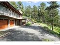 View of the home showing attached multi-car garage and staircase to backyard at 74 Sky Trail Rd, Boulder, CO 80302