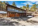 Two story modern home with wood-look garage doors and balconies at 74 Sky Trail Rd, Boulder, CO 80302