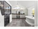 Elegant bathroom with a modern shower, soaking tub, dual vanities, and stylish lighting creating a spa-like atmosphere at 8138 Captains Ln, Longmont, CO 80504