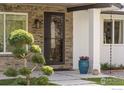 Close up shot of stone facade, statement front door, and landscaped entrance at 8138 Captains Ln, Longmont, CO 80504
