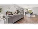 Open concept living space with hardwood floors and sight lines to kitchen at 8138 Captains Ln, Longmont, CO 80504