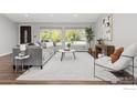 Bright living room with large windows, contemporary furniture, and stylish decor creating an inviting and comfortable space at 8138 Captains Ln, Longmont, CO 80504