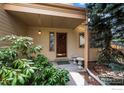 Inviting front entrance with a cozy porch and attractive landscaping at 851 Racquet Ln, Boulder, CO 80303