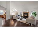 Bright living room with hardwood floors, vaulted ceilings, and a cozy fireplace at 851 Racquet Ln, Boulder, CO 80303