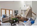 Spacious living room featuring hardwood floors, a staircase, and comfortable seating at 851 Racquet Ln, Boulder, CO 80303