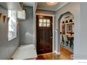Welcoming entryway with hardwood floors, a stylish bench, and a view into the dining room at 1150 Eudora St, Denver, CO 80220