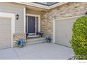 Charming entrance with stone accents, a three car garage and a beautifully landscaped yard at 11722 Elmer Linn Dr, Longmont, CO 80504