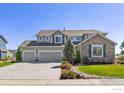 Craftsman home features a three-car garage and manicured lawn under a clear blue sky at 11722 Elmer Linn Dr, Longmont, CO 80504