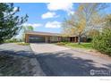 Well-maintained ranch home showcasing a paved driveway and a two-car garage at 1198 Crestmoor Dr, Boulder, CO 80303
