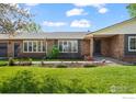 Ranch-style home features a manicured lawn and beautiful landscaping at 1198 Crestmoor Dr, Boulder, CO 80303
