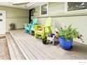 A cozy front porch featuring a set of Adirondack chairs and potted plants and a view of the front yard at 1247 Westview Dr, Boulder, CO 80303