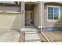 Close up of a home's inviting covered front entrance with stone steps at 12853 E 108Th Ave, Commerce City, CO 80022