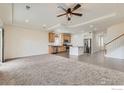 Open concept living area featuring plush carpeting, tray ceiling, and lots of natural light at 12853 E 108Th Ave, Commerce City, CO 80022