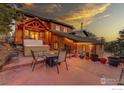 Outdoor patio with hot tub, outdoor seating, and landscaped yard, perfect for entertaining guests at 1319 County Road 83, Boulder, CO 80302