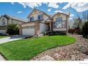 Beautifully maintained two-story home with a lush green lawn and inviting curb appeal at 1320 Indian Paintbrush Ln, Longmont, CO 80503