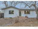 The home features a cozy entrance with a new wood landing, crisp white paint, and updated fixtures at 1498 Wicklow St, Boulder, CO 80303