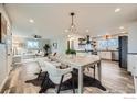 Open-concept living and dining area featuring modern decor, hardwood floors, and abundant natural light at 1498 Wicklow St, Boulder, CO 80303