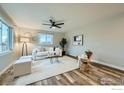 Bright and airy living room features neutral tones, modern furnishings, and large windows for ample natural light at 1498 Wicklow St, Boulder, CO 80303