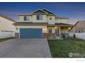Charming two-story home with a well-manicured lawn, inviting porch, and a two-car garage at 16315 9Th St, Mead, CO 80542
