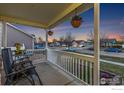 Cozy front porch with comfortable seating and hanging flower baskets, perfect for relaxing at 16315 9Th St, Mead, CO 80542