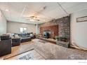 Cozy basement living room with a fireplace and comfortable seating area at 173 Jackson Ave, Firestone, CO 80520