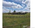 Charming home featuring a spacious yard, mature trees, and a classic ranch-style design at 205 S County Road 23, Berthoud, CO 80513