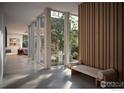 Bright hallway with large windows, wood accent wall, and bench seating with views of the outdoors at 2090 Orchard Ave, Boulder, CO 80304