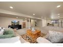 Spacious finished basement with plush carpeting, a television, and cozy seating for entertaining and relaxation at 2433 Tabor St, Berthoud, CO 80513