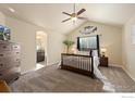 Bright primary bedroom with vaulted ceiling, and view into the bathroom; beautifully decorated with natural light at 2433 Tabor St, Berthoud, CO 80513