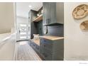 Organized mudroom featuring custom built-ins, storage, and a stylish rug, offering a functional and welcoming space at 267 Clementina St, Louisville, CO 80027