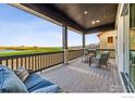 Inviting back porch with comfortable seating and scenic views of the lush golf course at 3010 Newfound Lake Rd, Berthoud, CO 80513