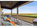 Relaxing back porch offers stunning views of the surrounding golf course and serene landscape at 3010 Newfound Lake Rd, Berthoud, CO 80513
