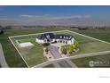 Sprawling property with a basketball court, a three-car garage, and lush landscaping at 3796 Vale View Ln, Mead, CO 80542