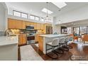 Modern kitchen boasts stainless appliances, skylights, large island with barstool seating at 3825 Northbrook Dr # F, Boulder, CO 80304