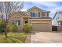 Charming two-story home with a well-maintained lawn, mature trees, and a two-car garage at 4170 Combine Pl, Brighton, CO 80601