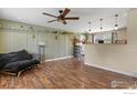 Open-concept living room with wood floors, stylish decorations and a large window providing ample natural light at 440 Fox St, Longmont, CO 80504