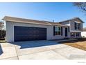Well-maintained home featuring a gray exterior, concrete driveway, and attached two-car garage at 4752 E 108Th Pl, Thornton, CO 80233