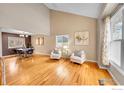 Bright living room featuring vaulted ceilings, hardwood floors, and lots of natural light at 4765 S Garland St, Littleton, CO 80123